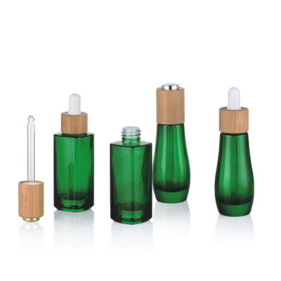 Glasflasche des ätherischen Öls mit kleiner Ölflasche des Bambuskinderbeständigen Tropfenzählers