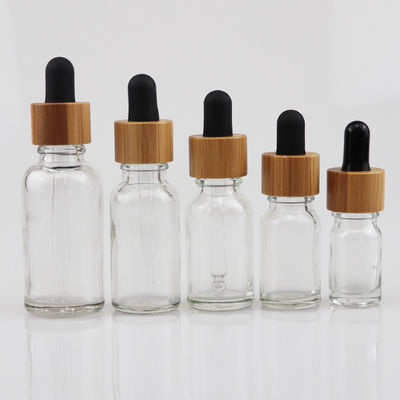 kosmetische Glasflasche des ätherischen Öls 100ml mit Bambustropfenzähler Sorgfalt-Haut Brown