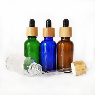 Glasflasche des ätherischen Öls mit kleiner Ölflasche des Bambuskinderbeständigen Tropfenzählers