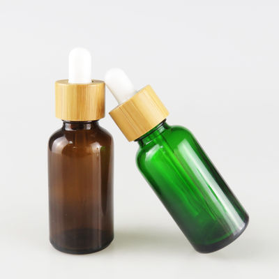 Glasflasche des ätherischen Öls mit kleiner Ölflasche des Bambuskinderbeständigen Tropfenzählers
